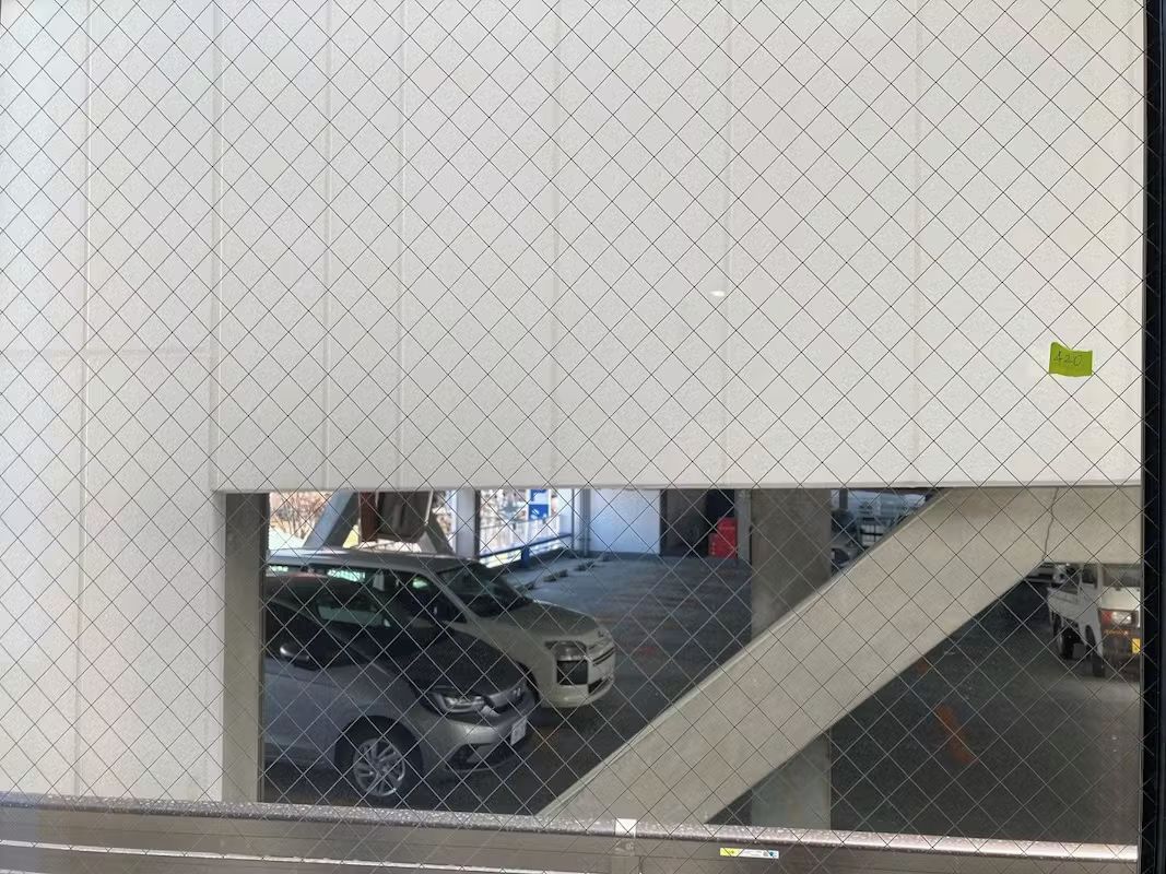 A parking garage with a car and a truck.