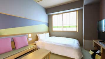 A hotel room with a bed, a small table, a bench, a TV, and a window.
