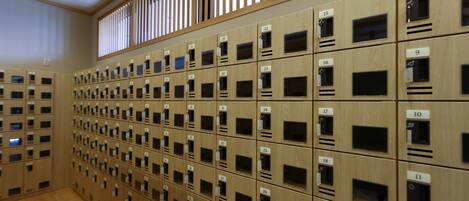 A row of wooden lockers with numbered labels, arranged in a grid pattern.