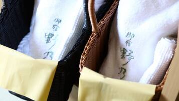 A close-up of a woven bag with a yellow strap and a white interior with embroidered text.