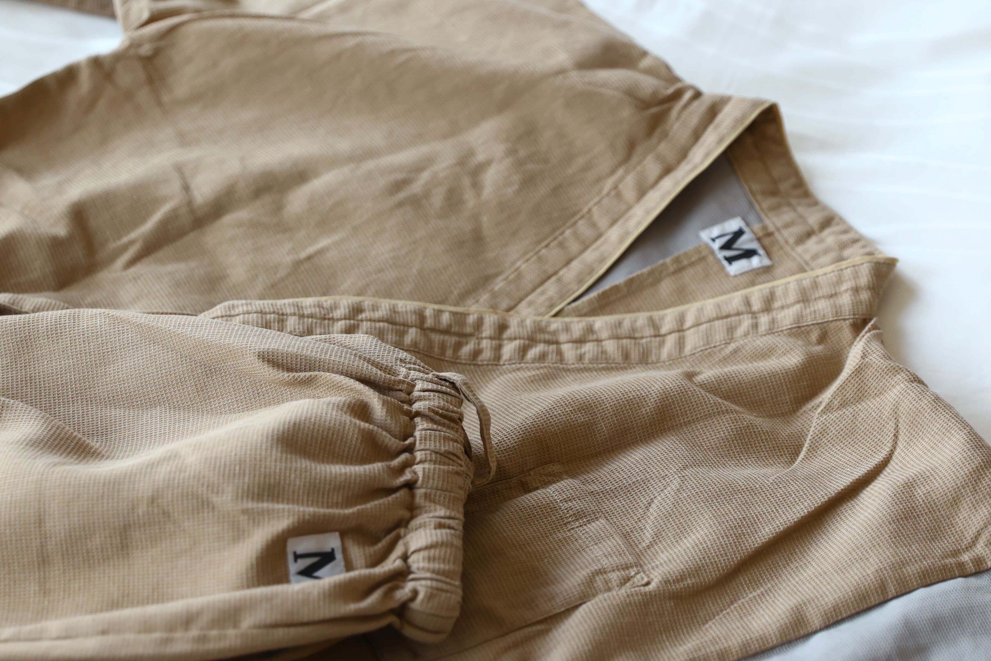 A pair of beige pants with a visible "Z" and "M" tag on the waistband.