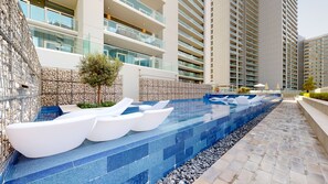 Outdoor pool - WelHome - Cozy 1BR With Private Balcony Steps From the Canal (Dubai)