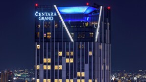 A high-rise building with the sign "CENTARA GRAND" prominently displayed. - Centara Grand Hotel Osaka (Osaka)