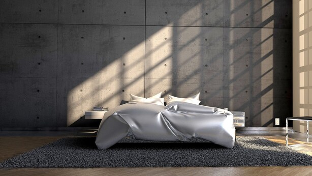 Un dormitorio moderno con una cama, una mesita de noche y una pared con diseño geométrico.
