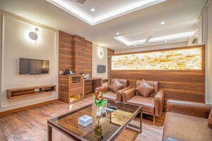 Luxury Room, 1 King Bed, Smoking, City View | Living area | 32-inch LED TV with cable channels - Hotel Varun (Guna)