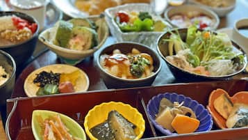 A variety of dishes in traditional bowls, suggesting a meal setting.
