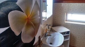 A bathroom with a white sink, a mirror, and a window. - Breathtaking View - Attic Apartment (Dubrovnik)