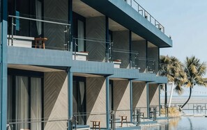 A multi-story hotel with balconies, a pool, and palm trees. - Hotel Tide Phuket (Ratsada)