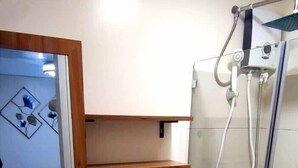 A modern bathroom with a sink, toilet, and glass-enclosed shower. - FULLY FURNISHED 2 BEDROOM CONDO UNIT (Pasig)