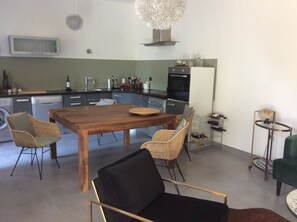 A modern kitchen with a dining area.