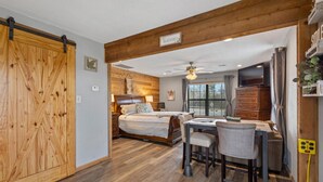 A cozy bedroom with a large bed, bedside tables, and a ceiling fan. - Cozy Hideaway in Denison Tx (Denison)