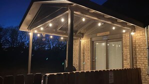 A covered outdoor area with a brick wall and a door labeled "PORCH". - Cozy Hideaway in Denison Tx (Denison)
