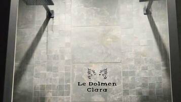 A tiled shower area with two overhead shower heads.