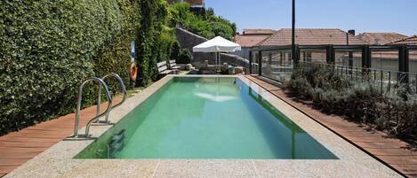 Outdoor pool, open 10:00 AM to 7:00 PM, pool umbrellas, pool loungers