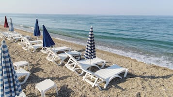 Sulla spiaggia, sabbia bianca, navetta per la spiaggia, lettini da mare