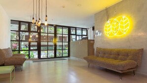 A modern interior with a sofa, a coffee table, and a wall-mounted light fixture.