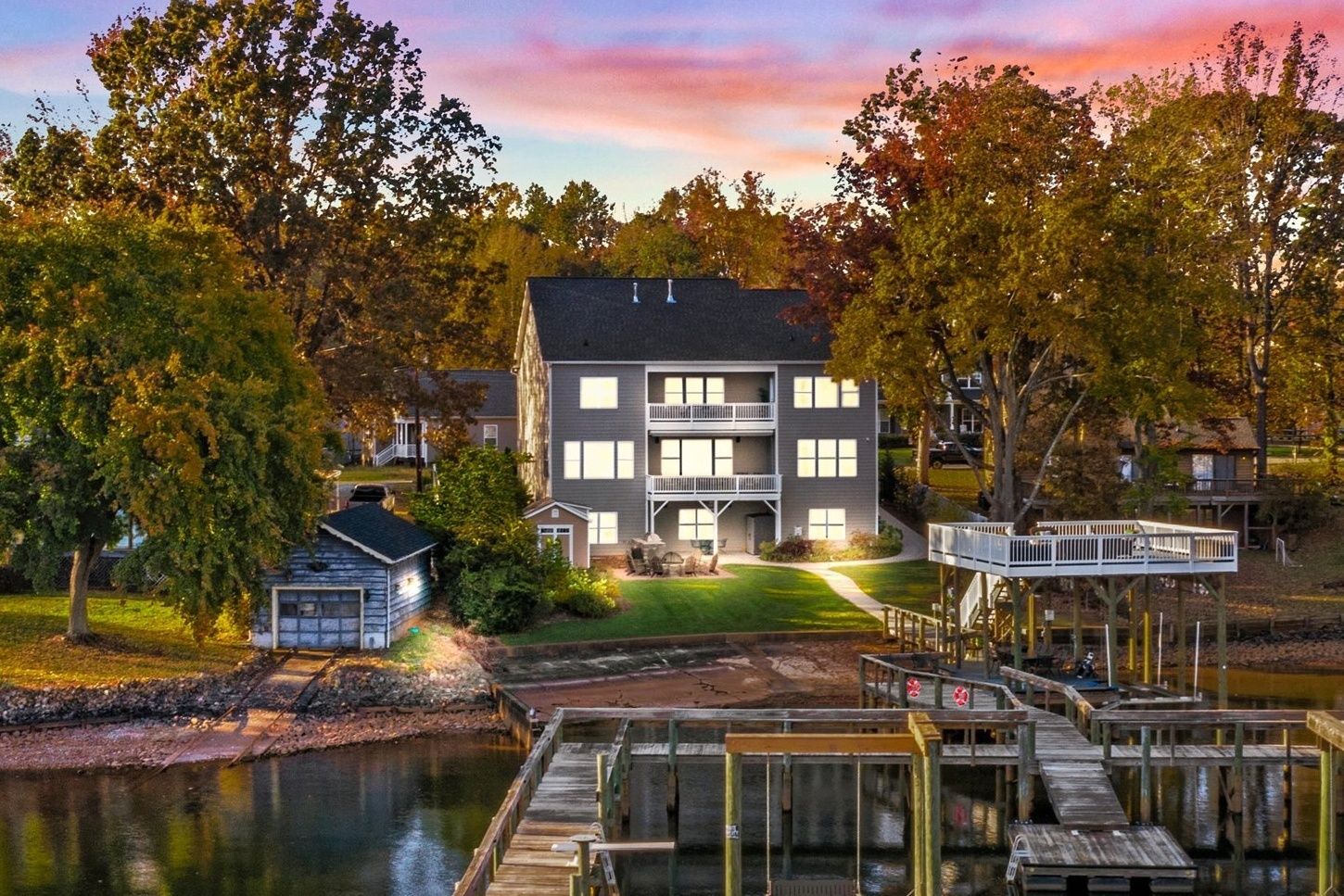 A multi-story building with a dock and a small shed.