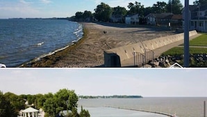 Une zone côtière comprenant une plage, une jetée et un bâtiment à la façade rouge.