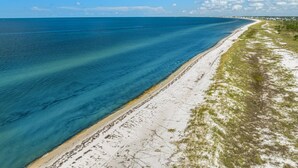 A coastal landscape with a sandy beach and a clear blue sea. - WaterView • NEW Boardwalk to Beach • Sleeps 15 • Resort Pools (Port St. Joe)