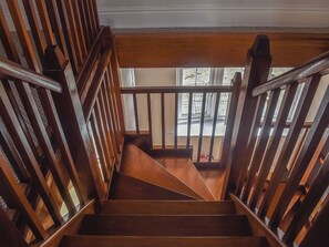 A wooden staircase with a handrail, leading to a landing with a window. - The Coach House - UK41070 (Wootton, near Ryde)