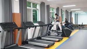 A gym with treadmills and exercise equipment.