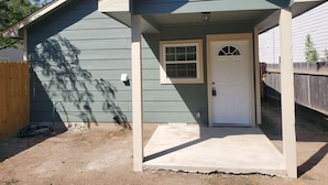 A single-story building with a front porch, a door, and a small window. - Sanctuary, Lackland AFB, SeaWorld Fiesta Texas (San Antonio)