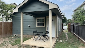 A small house with a porch, a table, and two chairs. - Sanctuary, Lackland AFB, SeaWorld Fiesta Texas (San Antonio)
