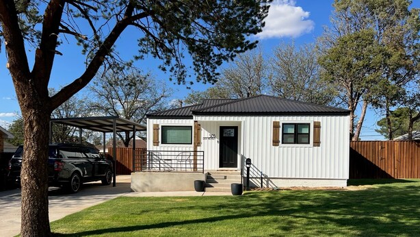 A single-story house with a covered patio, a front door, and a small front yard. - Updated Bungalow - Close to town and 30 min from Lubbock! (Brownfield)