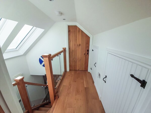 A staircase with wooden railings and a skylight. - 2 bedroom accommodation in Torrin, Isle of Skye (Torrin, Isle of Skye)