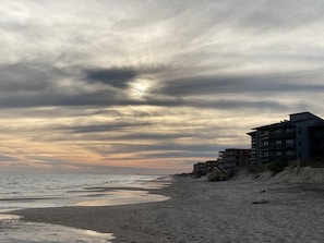 A beach with buildings along the shore. - Relaxing Oceanfront Condo w Priv Beach Access, Pool, Elevator. Linens Included (North Topsail Beach)