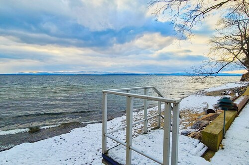 Lakefront home with deck, private beach, firepit, WiFi, & W/D - quiet location