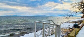 Lakefront home with deck, private beach, firepit, WiFi, & W/D - quiet location