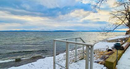 Lakefront home with deck, private beach, firepit, WiFi, & W/D - quiet location