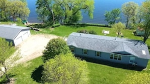 A house with a large lawn and a view of a lake. - Beautiful Lake front property on Big Stone Lake (Clinton)