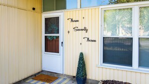 A house with a door, a window, and a sign that reads "Three Seventy Three." - Mid-Century Modern Themed Surf House (Vermilion)