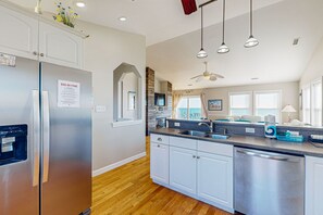 Enjoy cooking in this well-equipped kitchen with a refrigerator, dishwasher, sink, and microwave.