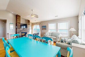 Relax in a spacious living area with a large dining table and comfortable seating.