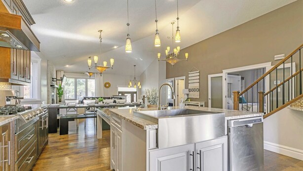 A spacious kitchen with a central island, stainless steel appliances, and a modern design. - Grovenor. Sleeps 14. Family Home. Triple Garage. (Edmonton)