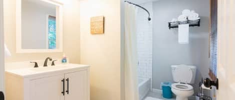 Shower, hair dryer, towels, toilet paper