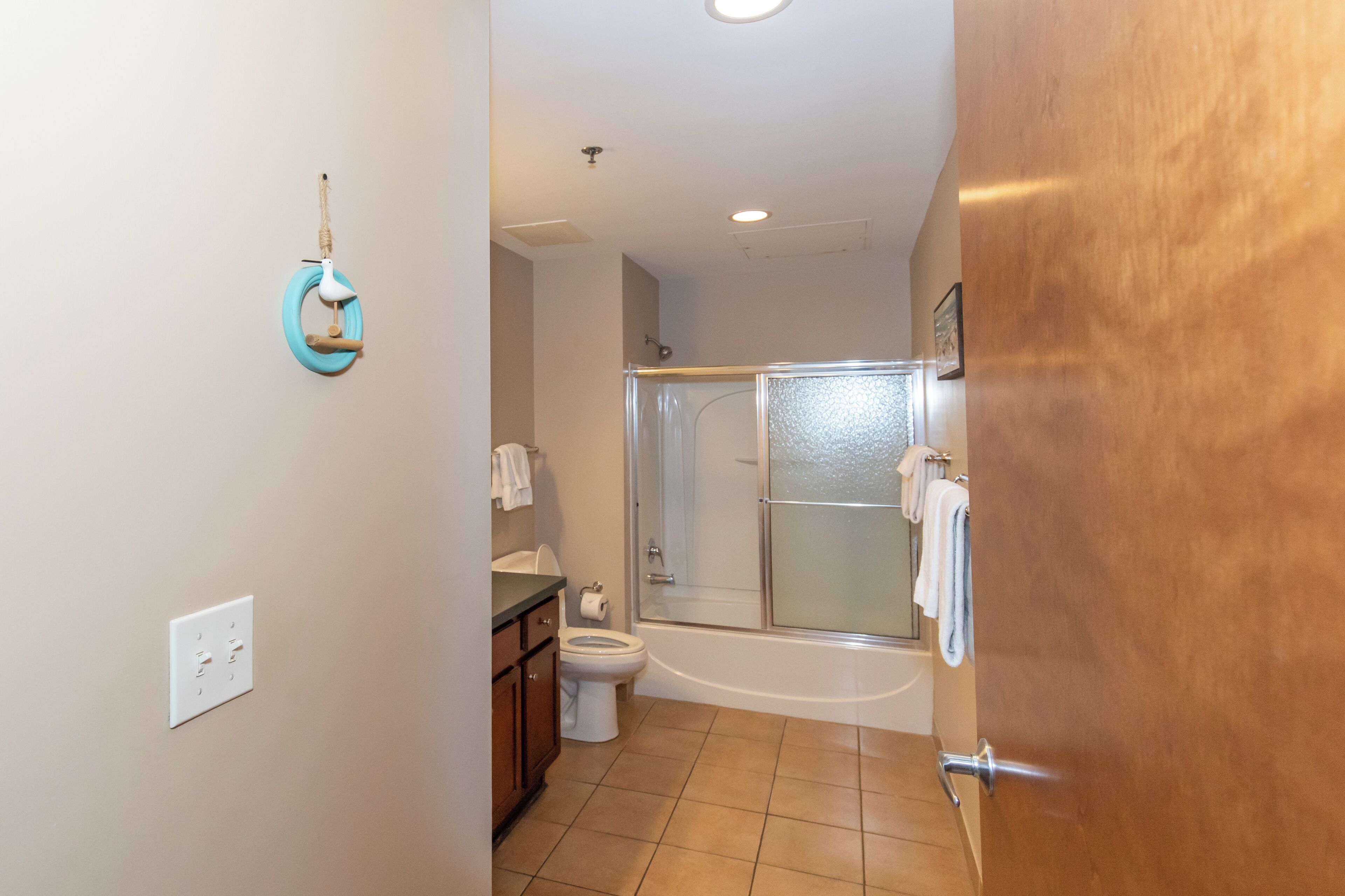 A bathroom with a toilet, sink, and shower.