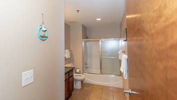 A bathroom with a toilet, sink, and shower.