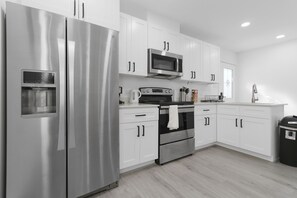 Enjoy cooking in this well-equipped kitchen with a refrigerator, microwave, and oven.