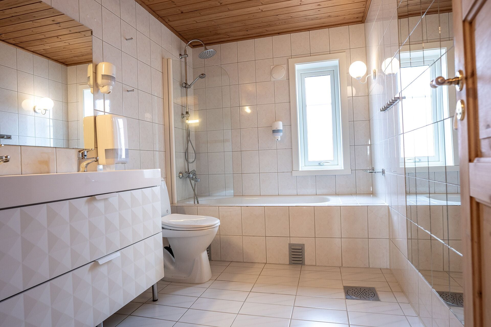 A bathroom with a shower, toilet, and bathtub.