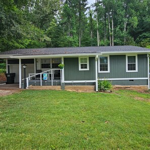 A two-story house with a porch, a garage, and a well-maintained lawn.