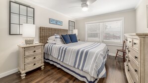 A bedroom with a bed, dresser, nightstand, and a ceiling fan. - The Roosevelt Suite (2 BEDROOMS/2 BATHS) (Stuart)