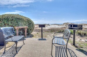 Relax in this serene outdoor space with a grill and seating for two.