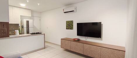 A modern kitchen with a built-in stove, a refrigerator, and a microwave.