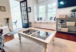 Relax in a spacious living room with a comfortable seating area and a view of the outdoors.