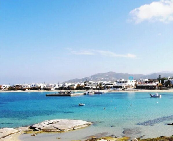 Stunning coastal town with a picturesque sea view and distant mountain range.