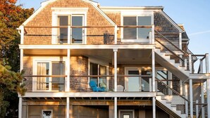 A multi-story house with a balcony, a garage, and a staircase. - Luxury Waterfront Property 360 water views (Portsmouth)
